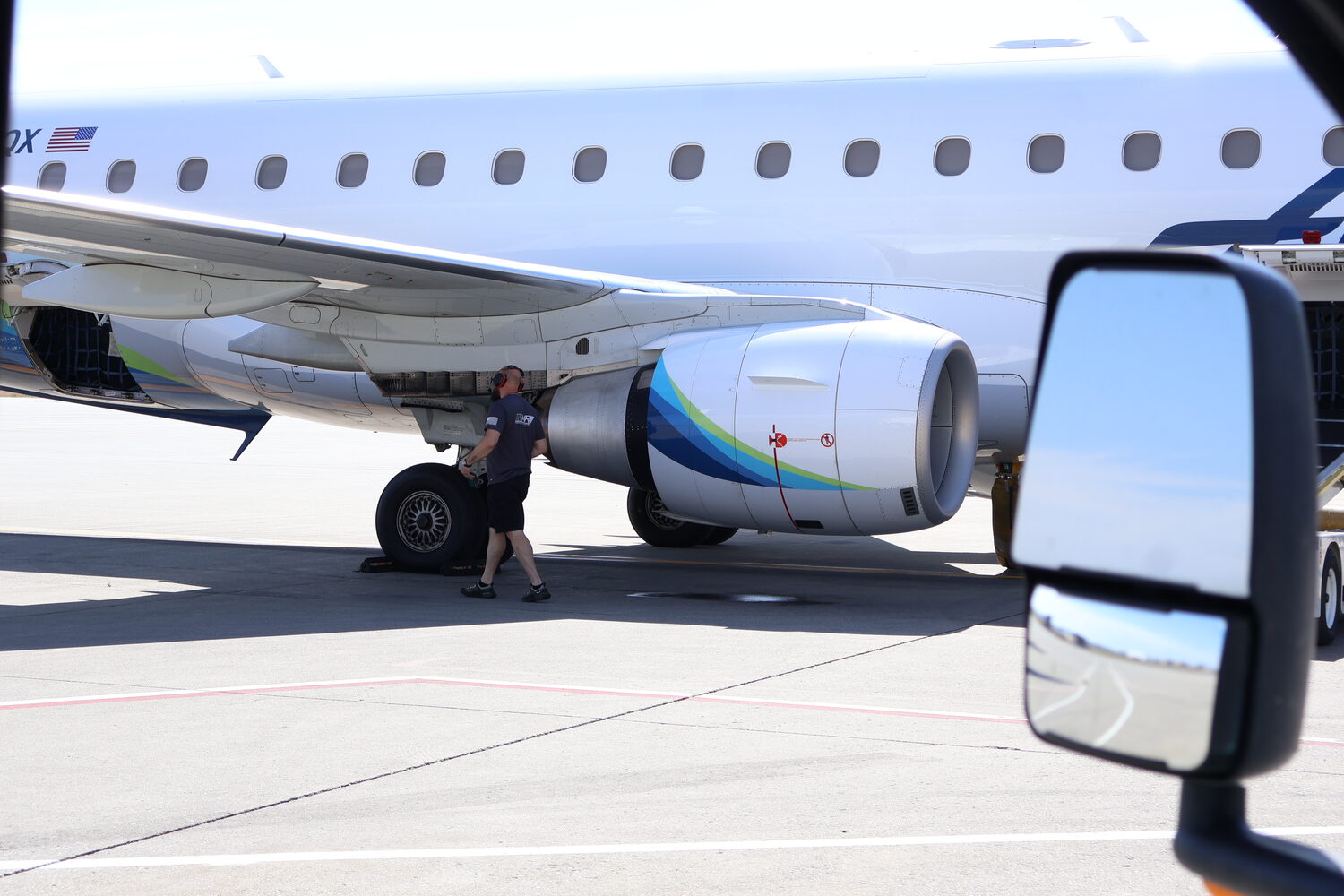 PB Air technician performing line maintenance on a regional jet at KGEG